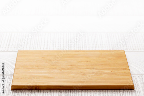 Wooden cutting board on white kitchen table