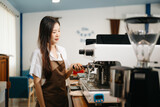 Asian female coffee shop owner in a coffee shop.