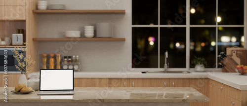 A laptop mockup on a marble kitchen island in a modern minimal Scandinavian kitchen.