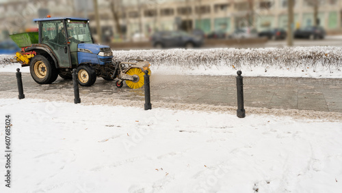 Salting Winter Road Maintenance, Road Salt Mini Tractor Spreader, Snow Plow Truck on Icy Street