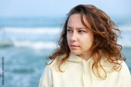 Upset young woman at beach