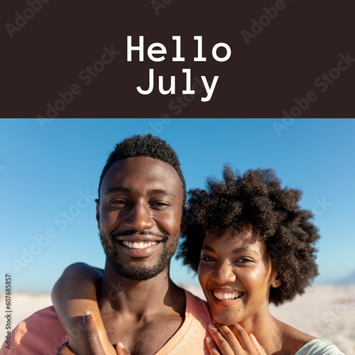 Composition of hello july text over african american couple on beach