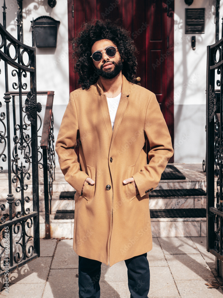 Handsome smiling hipster model. Unshaven Arabian man dressed in