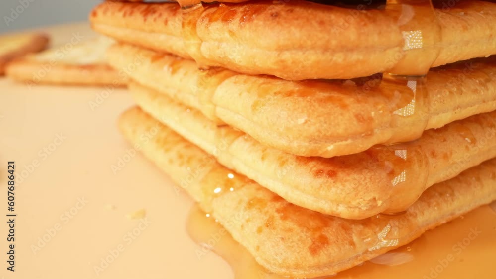 In this delectable scene, the star of the show is honey, which takes center stage as it glides gracefully over a bed of biscuits. The biscuits, adorned with a delicate layer of sugar crystals. 4K
In this delectable scene, the star of the show is honey, which takes center stage as it glides gracefully over a bed of biscuits. The biscuits, adorned with a delicate layer of sugar crystals. 4K