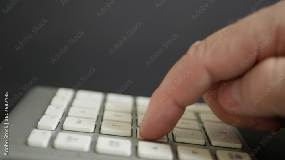 Blurred Shooting with a Businessman in the Office Making Financial Calculations Using a Computer Keypad. An employee in a Financial Corporation Using the PC Keypad. Blurred Shooting with a Businessman in the Office Making Financial Calculations Using a Computer Keypad. An employee in a Financial Corporation Using the PC Keypad.