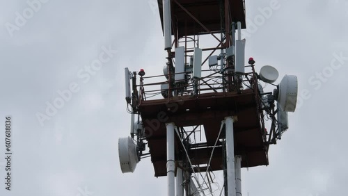Cell tower carrying antennas on sky with clouds background. Cellular networks. Mobile phone communication tower. Technology of telecommunication GSM tower. 5G or 6th generation network concept
