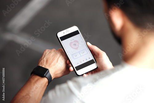 Fototapeta Naklejka Na Ścianę i Meble -  Fitness, app and man with phone, smart watch and workout schedule online at gym and sports training. Athlete with digital application, heart rate tracker and tech for exercise and health on cellphone