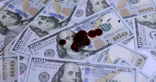 Dollars in red blood stains and criminal problems. Illegal sale of money and contract killing
