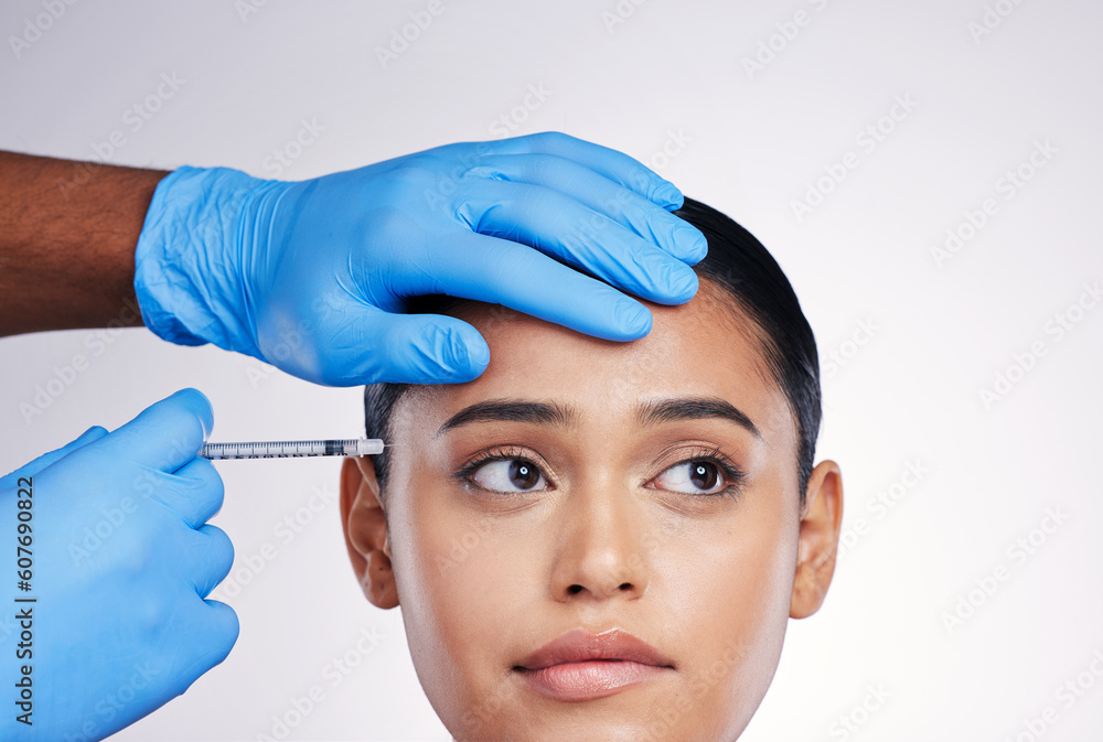 Woman, studio and injection with hands, surgery or worry with thinking, doubt or collagen by white background. Girl cosmetic surgeon and filler with idea, pain or fear for beauty, skincare or change Woman, studio and injection with hands, surgery or worry with thinking, doubt or collagen by white background. Girl cosmetic surgeon and filler with idea, pain or fear for beauty, skincare or change