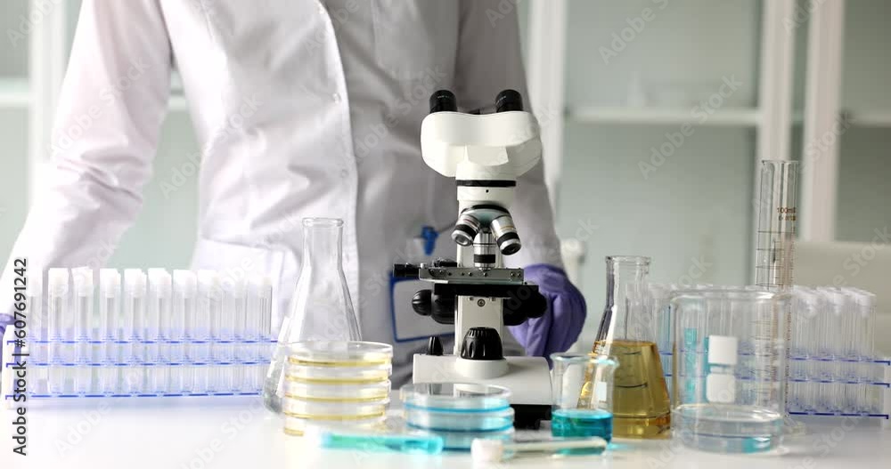 Scientist doctor biologist sit down at workplace in laboratory. Scientific research and chemical analysis of toxic substances Scientist doctor biologist sit down at workplace in laboratory. Scientific research and chemical analysis of toxic substances