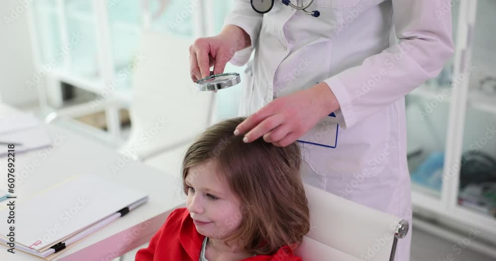 Trichologist examines condition of child girl hair. Lice nits and dandruff in children Trichologist examines condition of child girl hair. Lice nits and dandruff in children