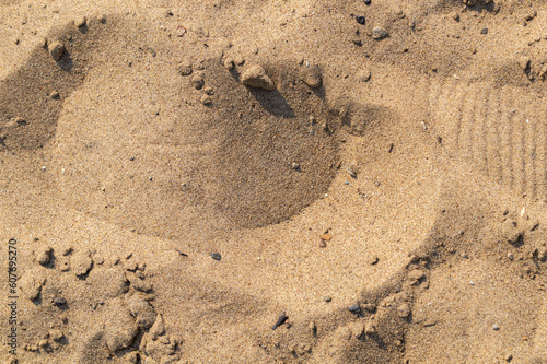 Footprints of shoes on the sand as a texture, pattern, background