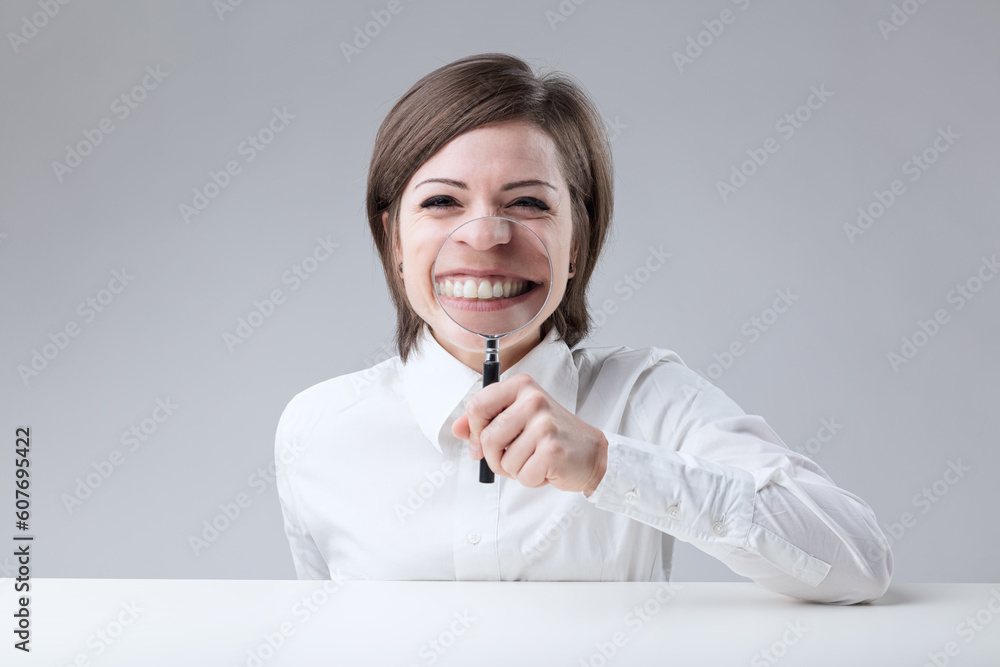 Young woman with short hair on a neutral background makes a funn Young woman with short hair on a neutral background makes a funn
