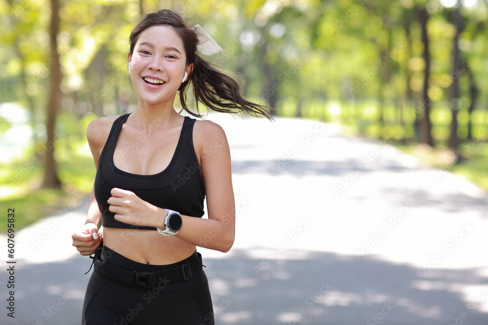 Premium Photo  Portrait of sportswoman smiling outdoors in morning. female  in running outfit standing outdoors in city.