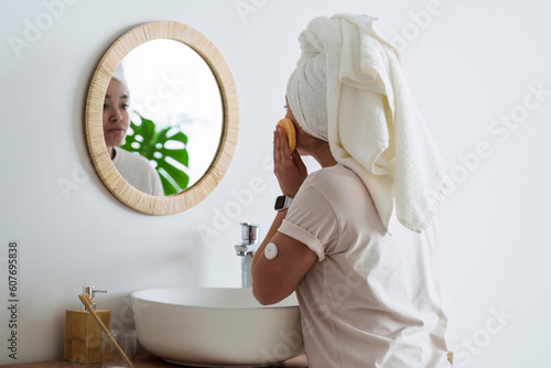Woman with diabetes doing morning routine in bathroom at home photo