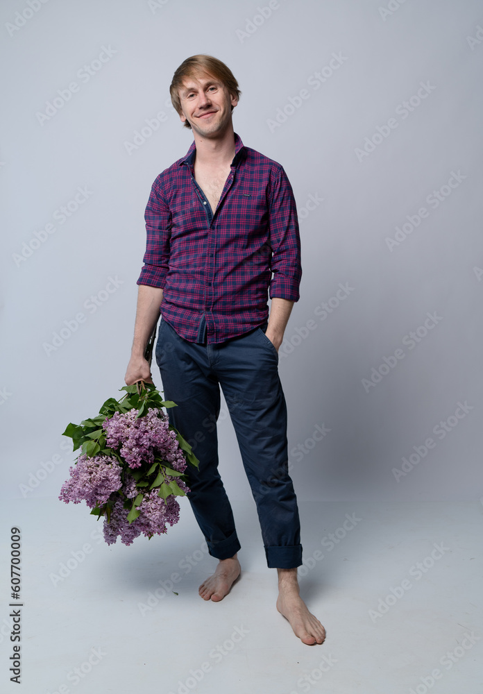 portrait of a man with a bouquet of flowers in the studio on a white background portrait of a man with a bouquet of flowers in the studio on a white background