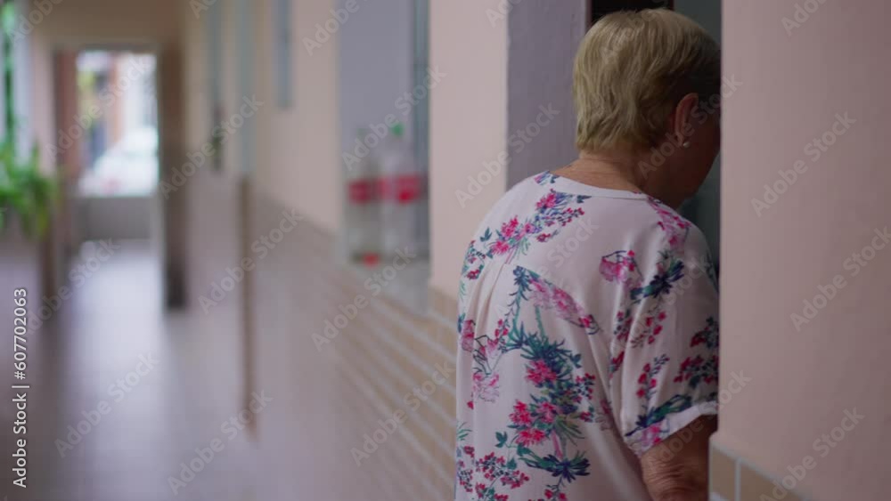 Senior woman entering room at home. Domestic lifestyle scene of elderly 80s person in residence Senior woman entering room at home. Domestic lifestyle scene of elderly 80s person in residence