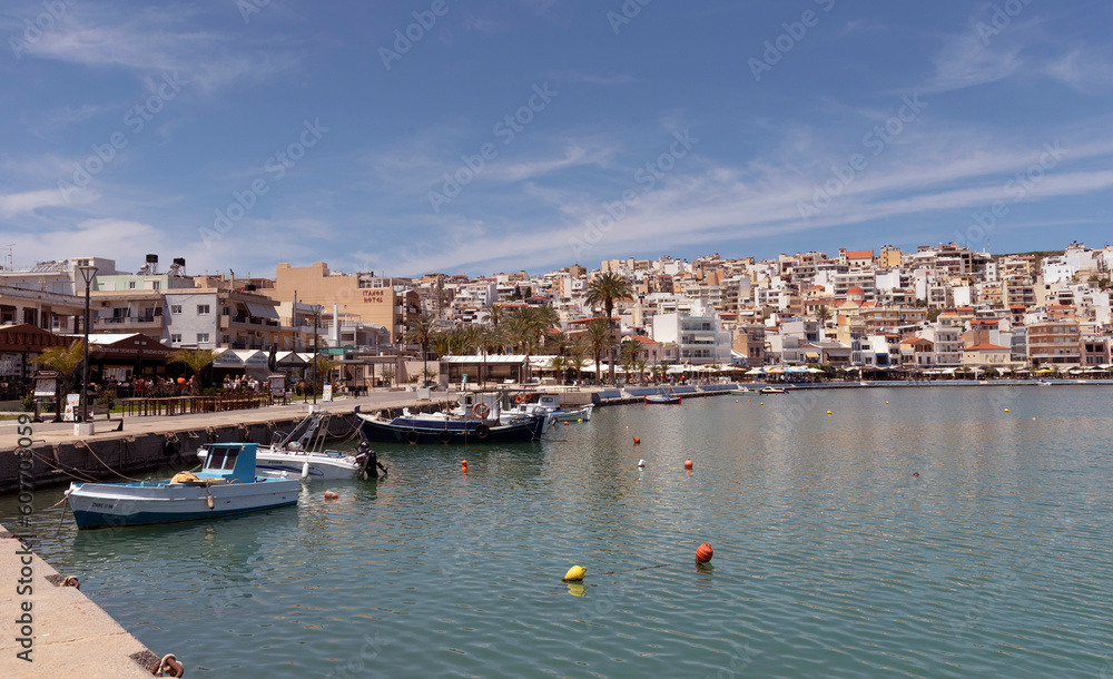 Sitia, Eastern Crete, Greece, Europe. 2023,  Waterfront of Sitia harbour in Eastern Crete with its small boats, hotels and restaurants on the seafront.