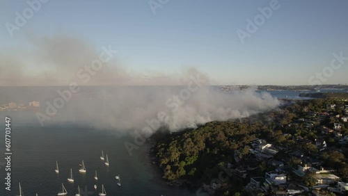 Aerial Footage side Pan Sydney Back burning fire El Nino 4K footage captures back burning, firefighting, smoke and helicopter rescues. May 29, 2023 Sydney Australia photo