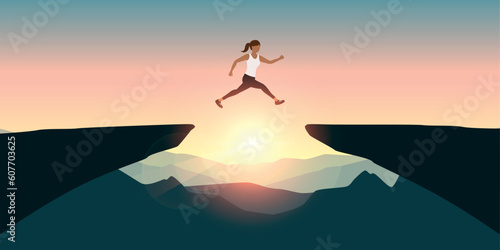 sporty woman successful jumping over a cliff on mountain landscape