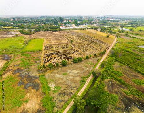 Aerial view of varied countryside with unpaved road, partly burned down farmland and trees, Phra Non, Nakhon Luang, Ayutthaya, Thailand. photo