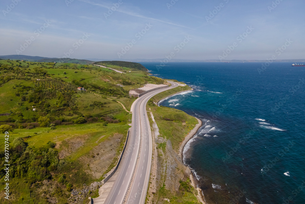 Aerial view of a serpentine road following the coastline along the Marmara Sea, Sevketiye, Lapseki, Turkey. Aerial view of a serpentine road following the coastline along the Marmara Sea, Sevketiye, Lapseki, Turkey.