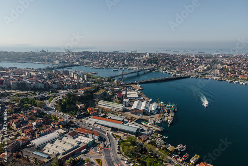 Aerial view of a boat sailing along the Golden Horn river estuary near the Galata bridge and the Ataturk bridge, Istanbul, Turkey. photo