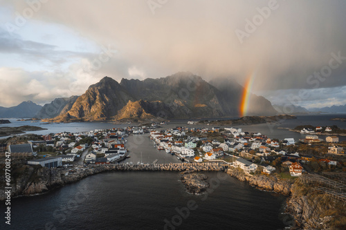 Aerial drone view of an rainbow over a nordic sea village in the Atlantic ocean, Henningsvaer, Lofoten, Norway. photo