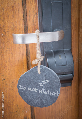 Door of hotel room with sign do not disturb