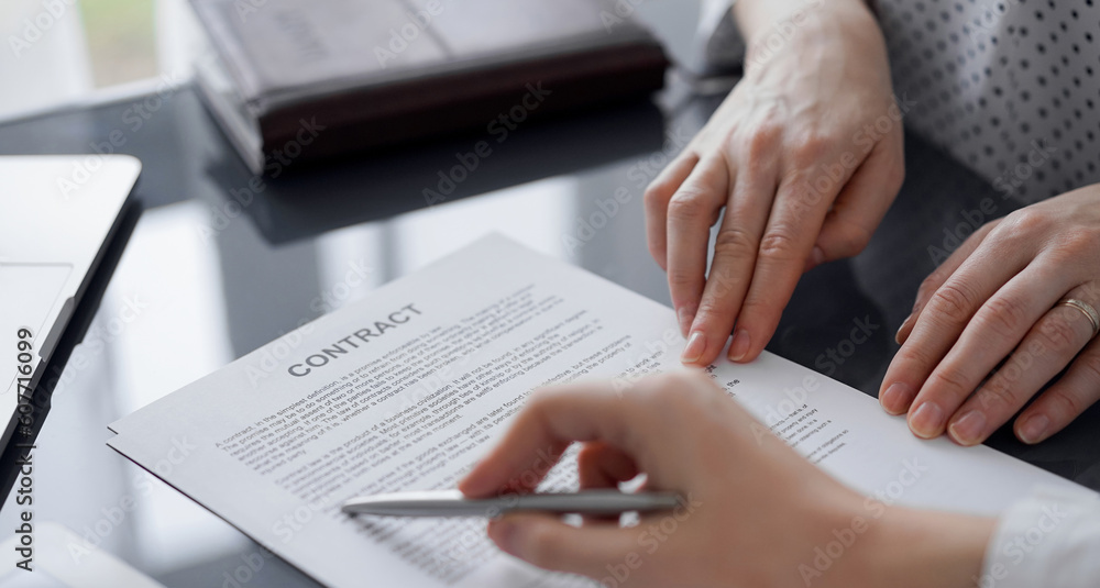 Business people discussing contract signing deal while sitting at the glass table in office, closeup. Partners or lawyers working together at meeting. Teamwork, partnership, success concept. Business people discussing contract signing deal while sitting at the glass table in office, closeup. Partners or lawyers working together at meeting. Teamwork, partnership, success concept.
