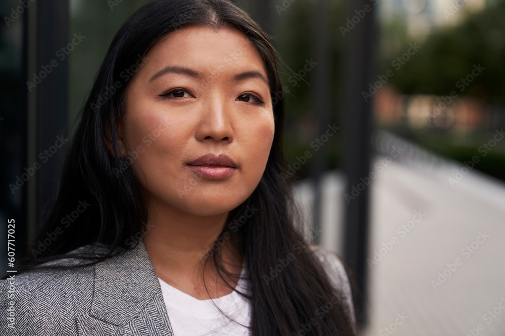 Close up portrait of business Chinese woman standing on the street