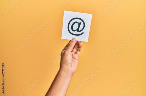 Fotografie Hand of caucasian man holding paper with @ message over isolated white backgroun