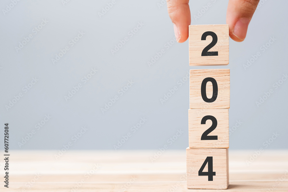 Hand Holding Wooden Cube Block With 2024 Text On Table Background   1000 F 607725084 TgDpPkWXmedOnjiyY7vmc4o8Tq0knTgD 