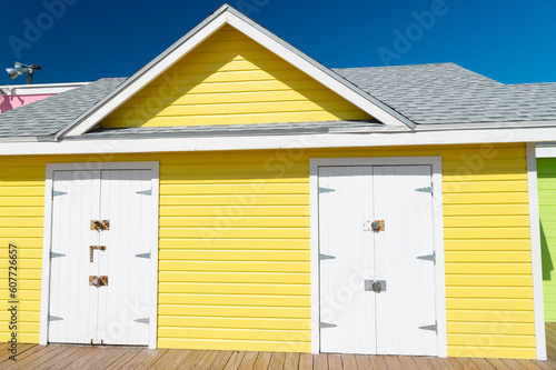 photo of bright beach hut in summer. yellow beach hut in summer vacation. beach hut in summer.