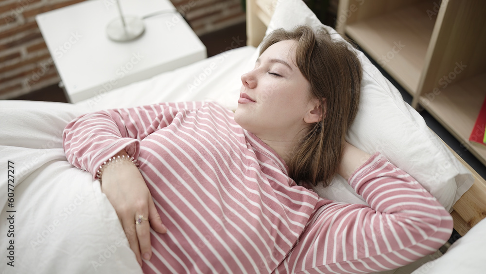 Young blonde woman lying on bed sleeping at bedroom Young blonde woman lying on bed sleeping at bedroom