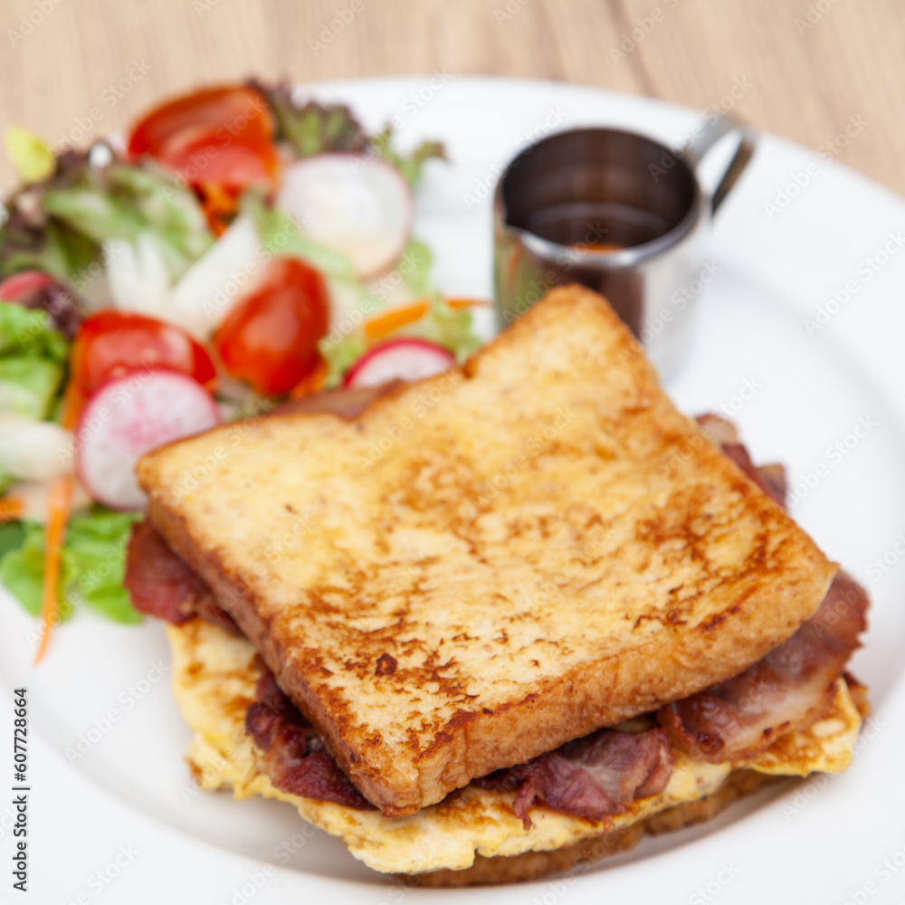 French toast with omelette and bacon for breakfast, brunch