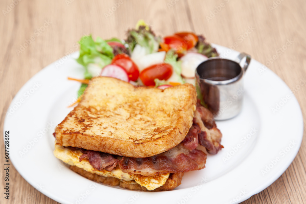 French toast with omelette and bacon for breakfast, brunch