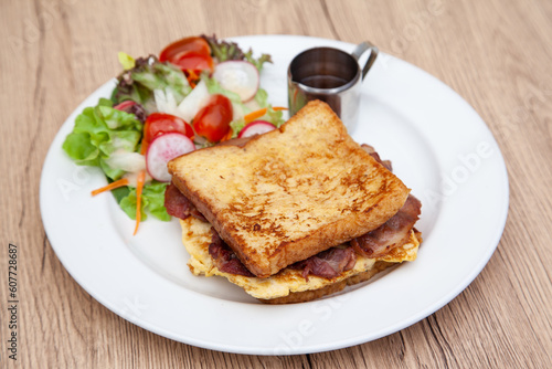 French toast with omelette and bacon for breakfast, brunch