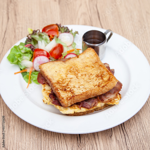 French toast with omelette and bacon for breakfast, brunch