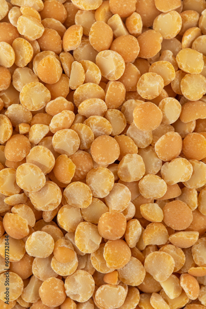 Yellow split dry peas close-up. Vegetable protein. Vertical photo. Yellow split dry peas close-up. Vegetable protein. Vertical photo.