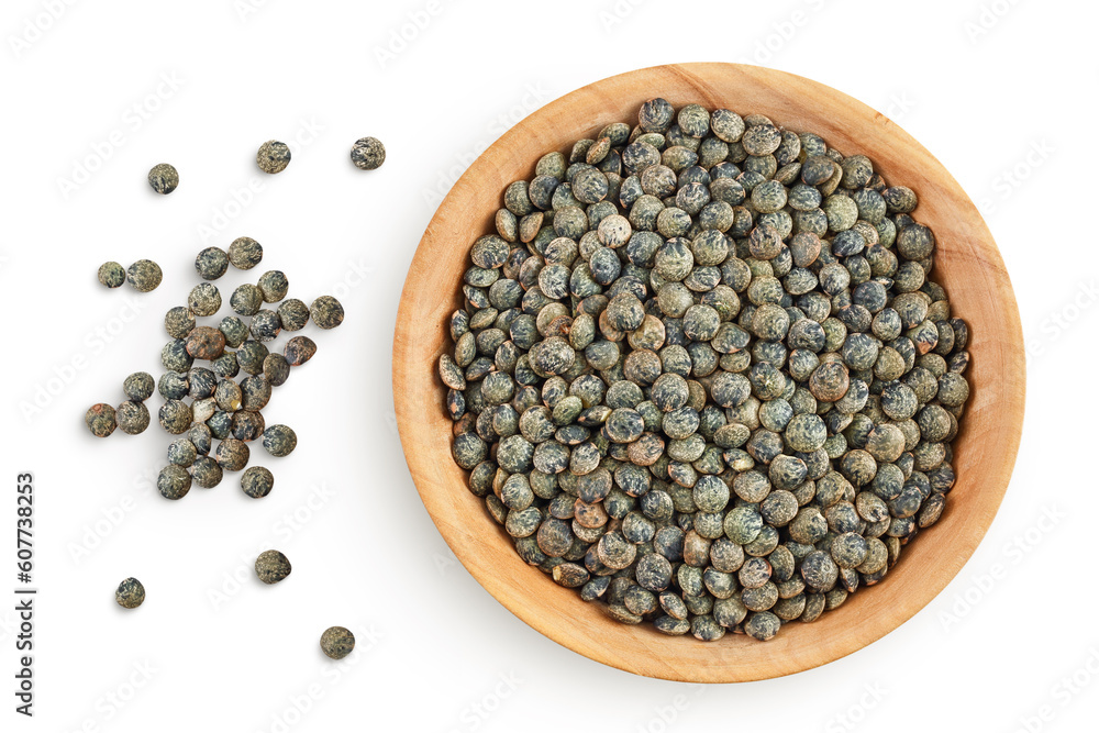 raw french green lentils in wooden bowl isolated on white background. Top view. Flat lay raw french green lentils in wooden bowl isolated on white background. Top view. Flat lay