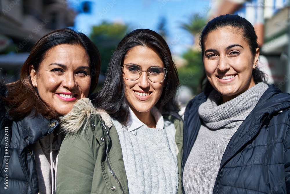 Three woman mother and daughters standing together at street Three woman mother and daughters standing together at street