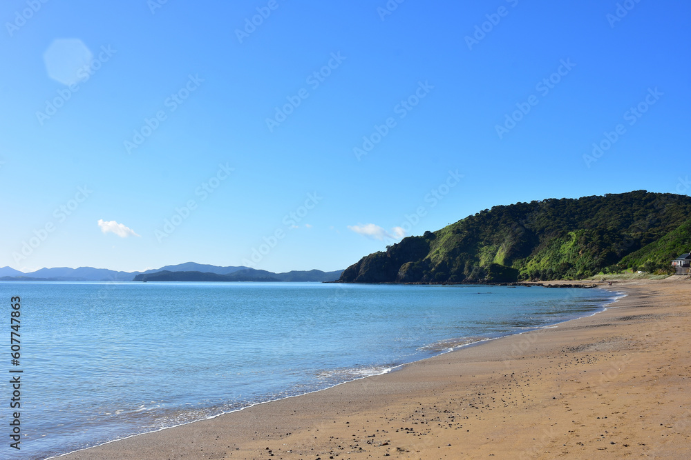 Calm sea with practically no surf wave at Long Beach in Russell. Location: Russell New Zealand