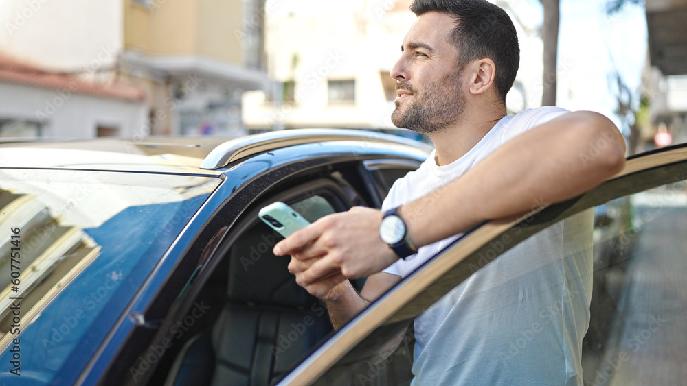 Young hispanic man using smartphone leaning on car at street Young hispanic man using smartphone leaning on car at street