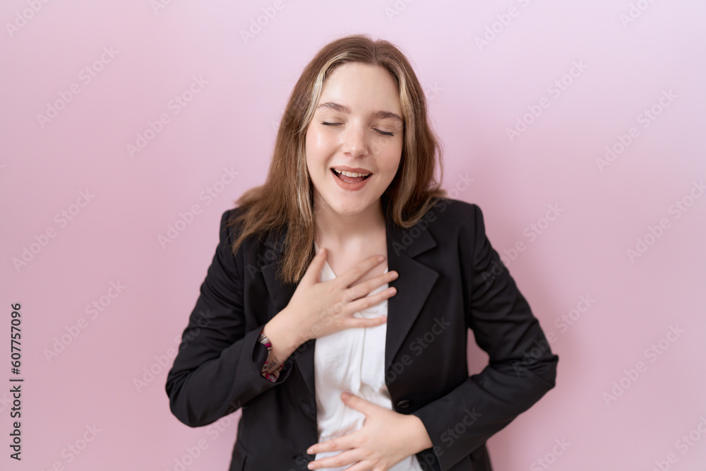 Young caucasian business woman wearing black jacket smiling and laughing hard out loud because funny crazy joke with hands on body. Young caucasian business woman wearing black jacket smiling and laughing hard out loud because funny crazy joke with hands on body.