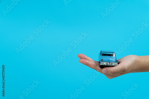 Hand holding a toy car