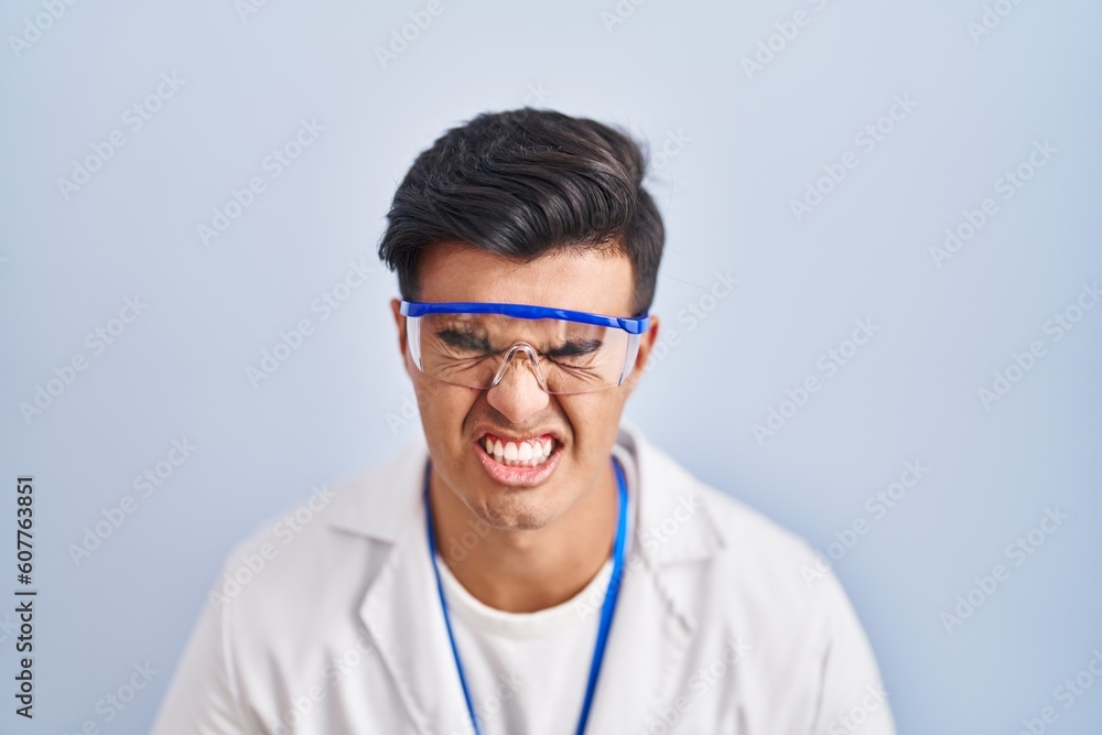 Hispanic man working as scientist with hand on stomach because indigestion, painful illness feeling unwell. ache concept. Hispanic man working as scientist with hand on stomach because indigestion, painful illness feeling unwell. ache concept.