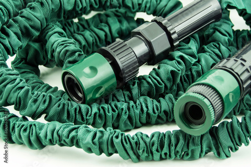 1 Green flexible garden hose close up photo