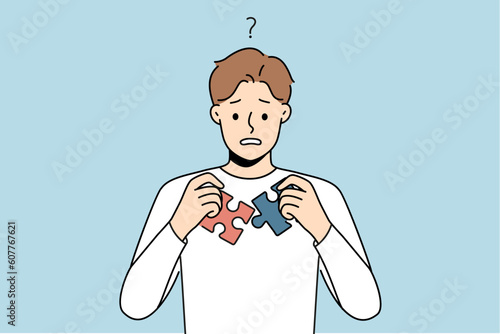 Confused man unable to join puzzle pieces. Frustrated guy brainstorm think about jigsaw connection. Problem solution and dilemma. Vector illustration. 