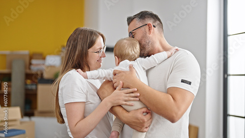 Family of mother, father and baby smiling together at new home © Krakenimages.com